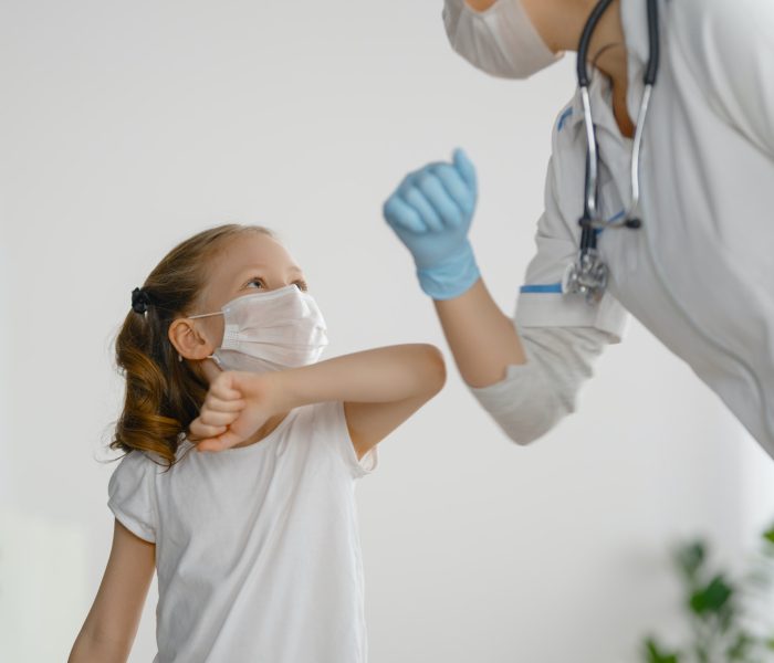 Doctor and child wearing facemasks